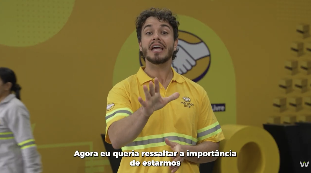Apresentador em cenário do Mercado Livre falando sobre a infraestrutura do centro de distribuição